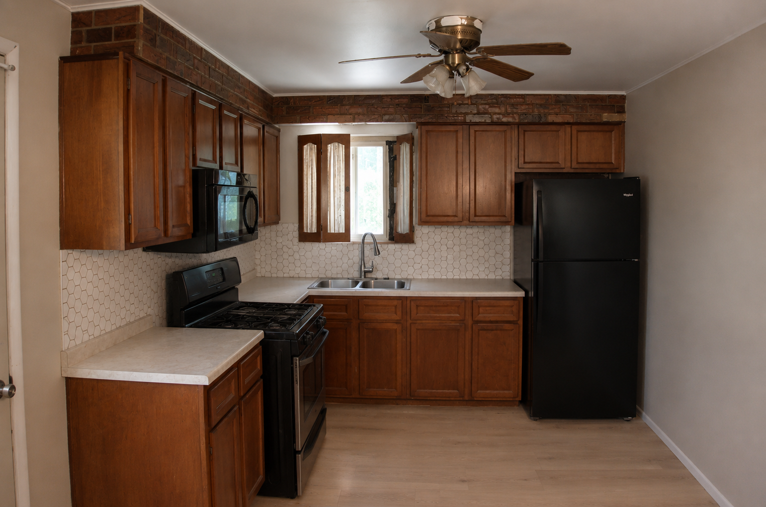 Chris's kitchen after the remodel — new LVP flooring and fresh wall finish